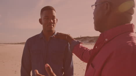 African-american-man-talking-to-his-son-at-the-beach