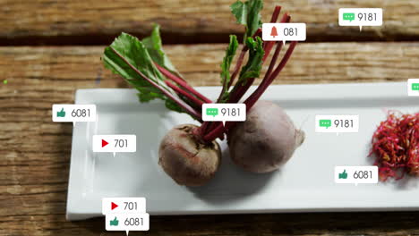 Animation-of-social-media-icons-foating-against-close-up-of-beetroot-and-sliced-beetroot-in-a-plate