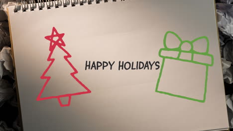 Animation-of-hand-drawing-happy-holidays-and-christmas-decorations-on-white-paper-background