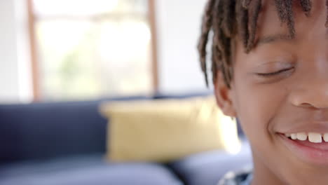 Half-portrait-of-happy-african-american-boy-at-home-with-copy-space,-slow-motion