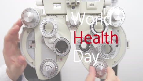 Animation-of-world-health-day-text-over-caucasian-male-optometrist-adjusting-equipment