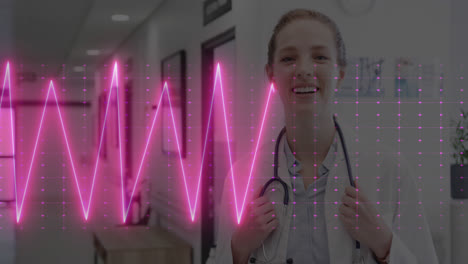 Animation-of-cardiograph-over-happy-caucasian-female-doctor-with-stethoscope
