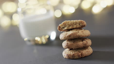 Video-of-christma-cookies,-glass-of-miljk-and-copy-space-on-grey-background