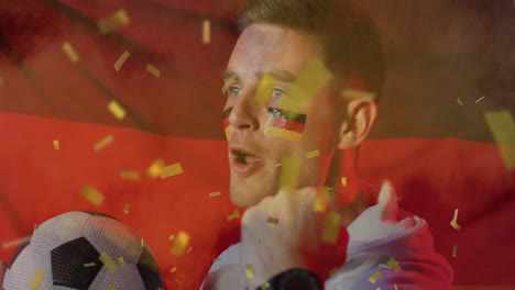 Animation-of-gold-confetti-over-cheering-caucasian-male-football-fan-with-flag-of-germany-face-paint