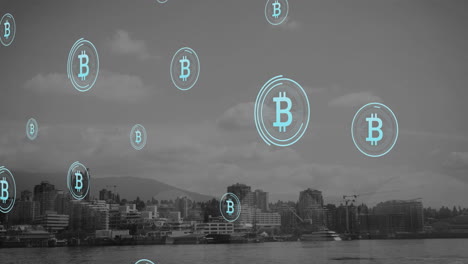 Animation-of-bitcoin-symbols-floating-against-aerial-view-of-cityscape