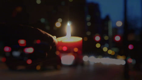 Animation-of-person-lighting-candle-over-out-of-focus-city-lights