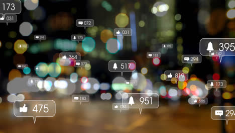 Animation-of-social-media-icons-against-blurred-view-of-night-city-traffic