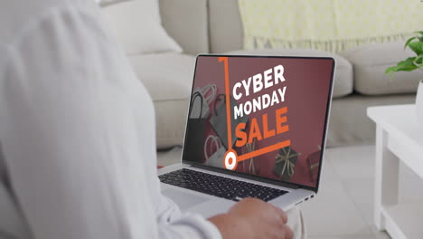 Biracial-Frau,-Die-Am-Cyber-Monday-Verkaufstag-Zu-Hause-Einen-Laptop-Zum-Online-Shopping-Nutzt,-Zeitlupe