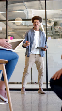 Vertical-video-of-happy-diverse-business-people-at-meeting-in-office-in-slow-motion