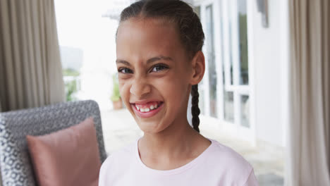 Portrait-of-happy-biracial-girl-at-home,-slow-motion