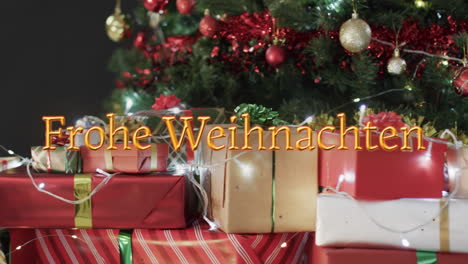 Frohe-weihnachten-text-in-orange-over-presents-and-lights-under-decorated-christmas-tree