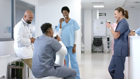 Diverse-healthcare-professionals-share-a-light-moment-in-a-hospital