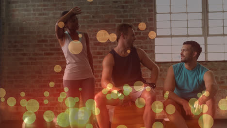 Animation-of-glowing-circles-over-multiracial-friends-talking-in-gym-after-workout