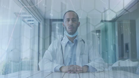 Animation-of-network-of-hexagons-over-biracial-male-doctor
