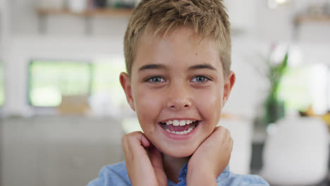 Portrait-of-happy-caucasian-boy-looking-at-camera-and-smiling,-slow-motion
