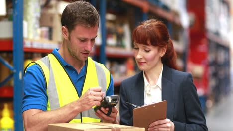 Warehouse-manager-and-delivery-driver-smiling-at-camera