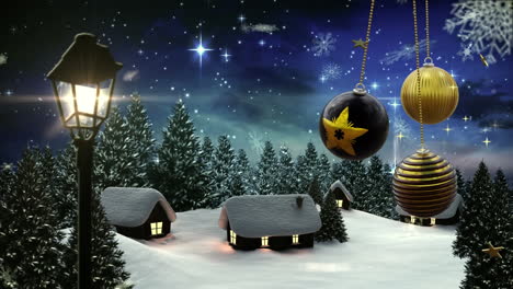 Swinging-black-and-gold-christmas-baubles-over-falling-snowflakes-on-winter-village-at-night