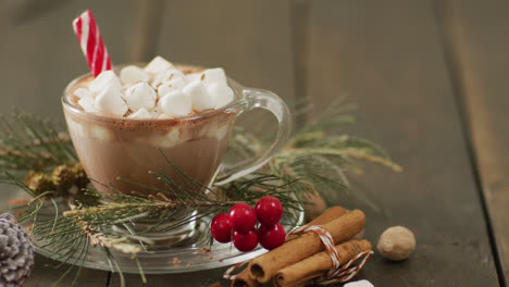 Video-of-cup-of-hot-chocolate-with-marshmallows-over-wooden-background