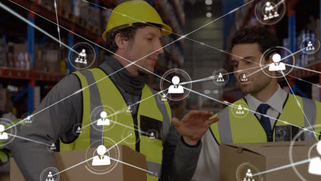 Animation-of-network-of-connections-with-icons-over-caucasian-men-working-in-warehouse