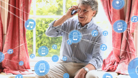 Animation-of-connected-icons-over-senior-caucasian-man-talking-on-cellphone-at-home