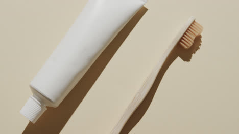 Close-up-of-toothbrush-and-toothpaste-on-beige-background