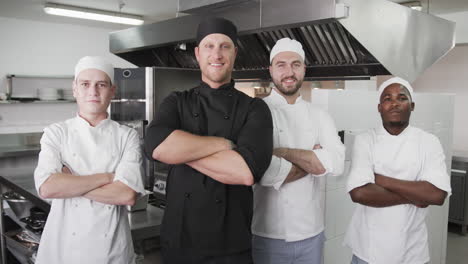Diverse-group-of-male-chefs-in-kitchen,-slow-motion