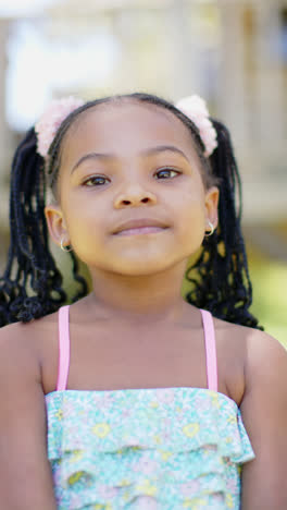 Vertical-video-of-portrait-of-happy-african-american-girl,-in-slow-motion