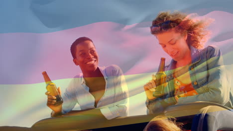Composite-video-of-waving-germany-flag-over-two-diverse-girls-drinking-beers-and-talking-in-the-car
