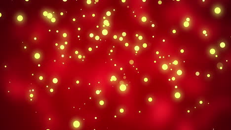 Glowing-yellow-christmas-light-particles-moving-across-red-bokeh-background