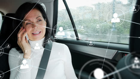 Animation-of-network-of-connections-over-happy-caucasian-woman-using-smartphone-in-car
