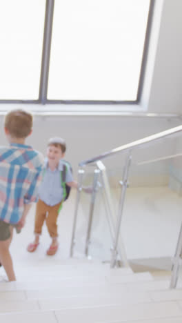 Video-of-diverse-boys-walking-on-stairs-at-school