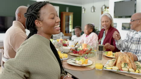 Portrait-of-african-american-mother-with-family-at-thanksgiving-dinner-table,-slow-motion