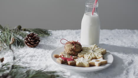 Video-of-christma-cookies,-bottle-of-milk-and-copy-space-on-white-background