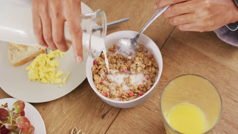 Video-of-hands-of-caucasian-man-preparing-cereals-for-breakfast