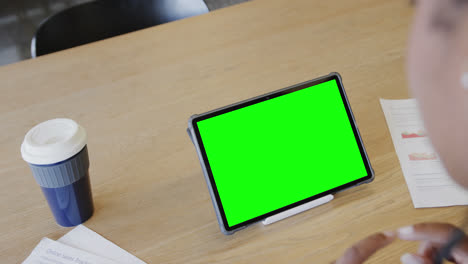 Caucasian-businesswoman-on-tablet-video-call-with-green-screen