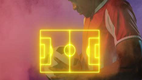Animation-of-yellow-football-pitch-and-smoke-over-african-american-male-football-player-holding-ball