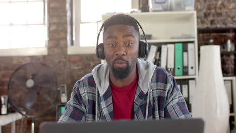 Focused-african-american-casual-businessman-having-laptop-video-call-in-office-in-slow-motion