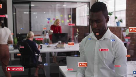 Animation-of-notification-labels-over-african-american-man-using-cellphone-in-office