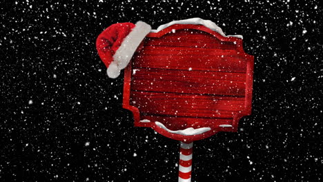 Animation-of-christmas-red-sign-with-copy-space-and-santa-hat,-snow-falling-on-black-background