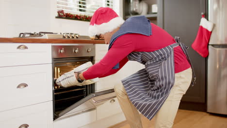 Biracial-man-baking-christmas-cookies-in-kitchen-at-home,-slow-motion