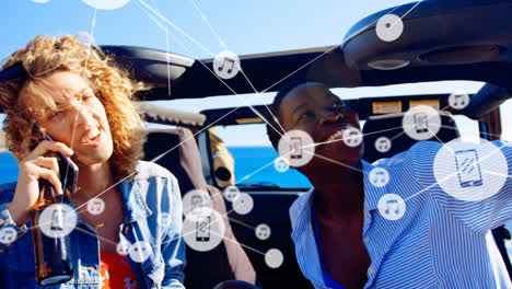 Animation-of-network-of-connections-over-happy-diverse-women-using-smartphone-in-car
