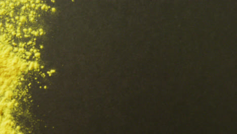 Video-of-yellow-powder-with-copy-space-on-black-background