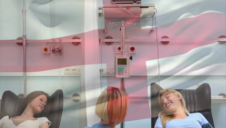 Animation-of-flag-of-england-over-caucasian-female-doctor-with-female-patients-in-hospital