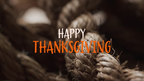 Animation-of-happy-thanksgiving-text-over-ropes-background