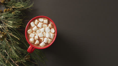 Video-of-cup-of-hot-chocolate-with-marshmallows-and-warm-blanket-over-black-background