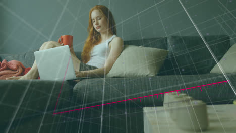 Animation-of-falling-graphs-and-arrow-over-caucasian-woman-drinking-coffee-and-working-on-laptop