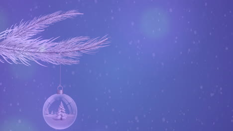 Animation-of-snow-falling-over-bauble-decoration-hanging-from-a-branch-against-blue-background