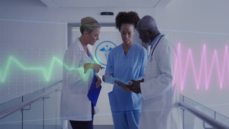 Animation-of-heart-rate-montior-against-diverse-doctors-and-health-worker-discussing-at-hospital