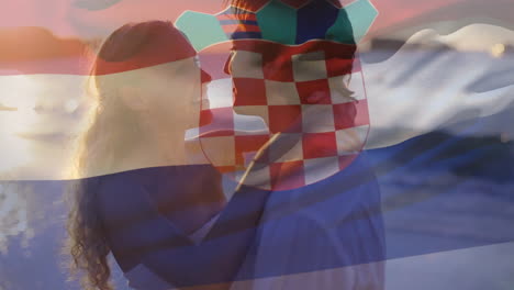 Composite-Video-Einer-Wehenden-Kroatischen-Flagge-Vor-Einem-Kaukasischen-Paar,-Das-Sich-Am-Strand-Umarmt