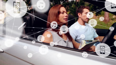 Animation-of-network-of-connections-over-happy-caucasian-couple-with-newspaper-in-car